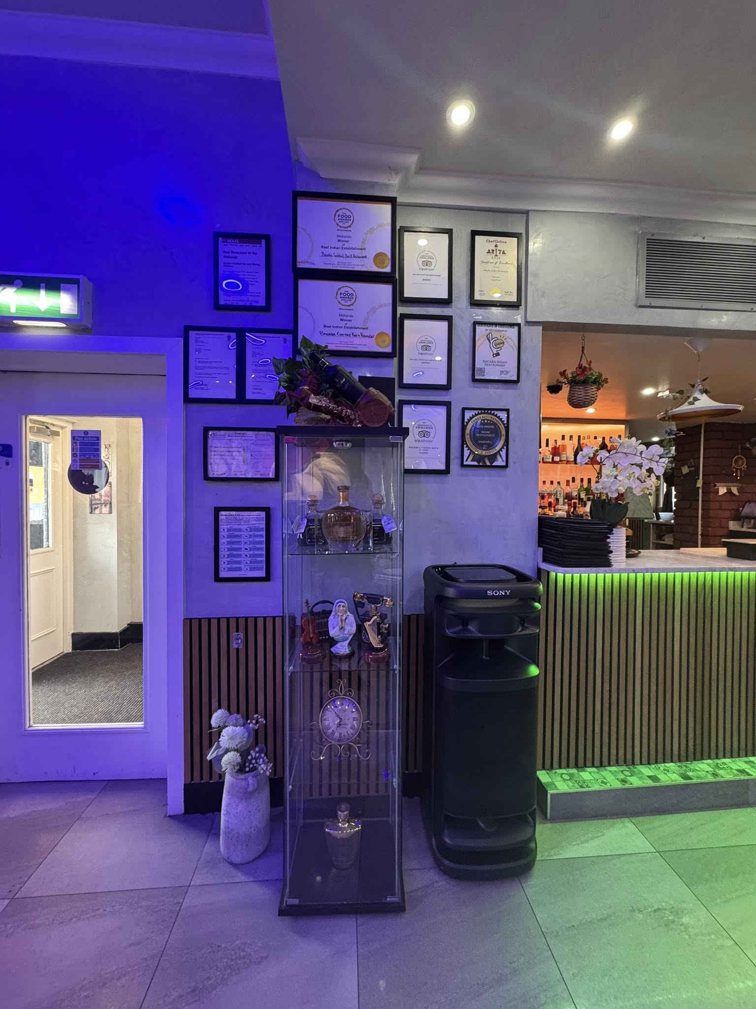 Bacaba Restaurant Oldbury, awards and certificates wall display with blue ambient lighting