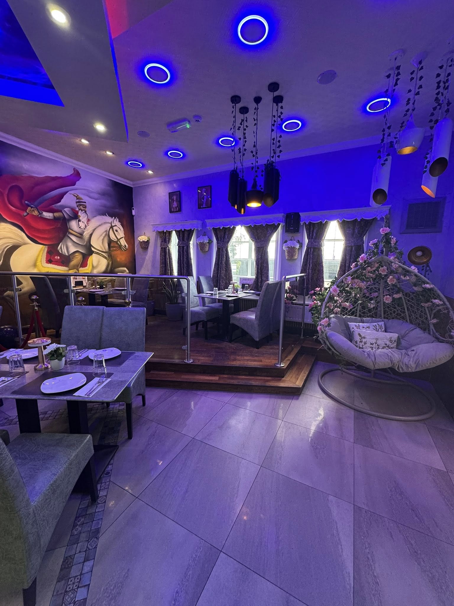 Bacaba Restaurant Oldbury, room with horse rider wall mural, blue lights and hanging egg chair