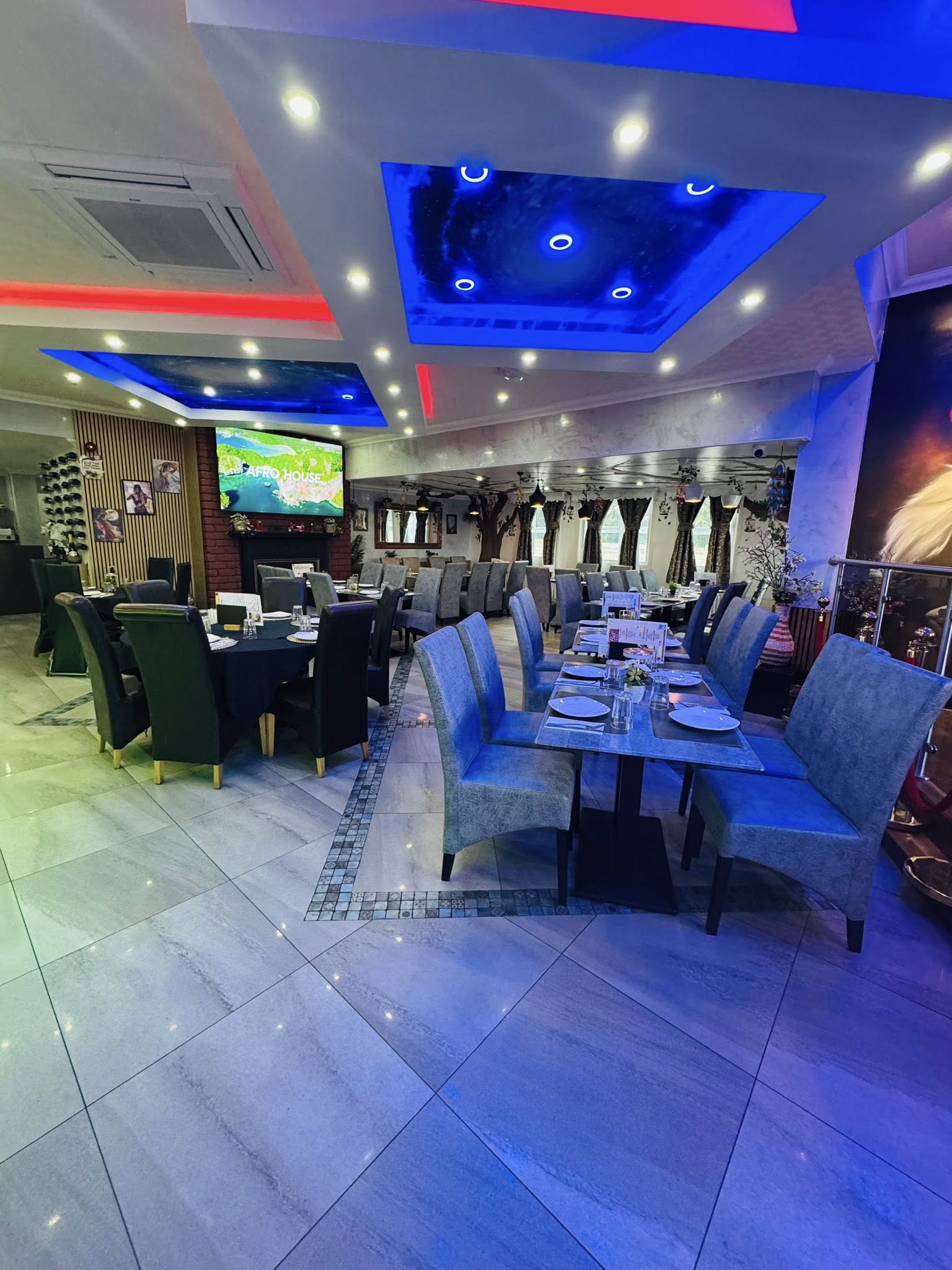 Bacaba Restaurant Oldbury, wide shot of main dining room with blue ceiling lights and TV area